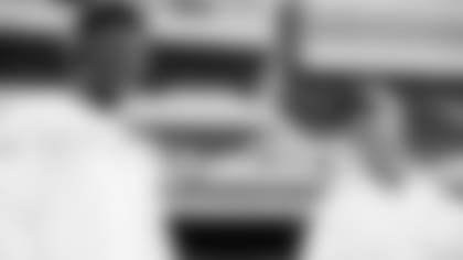 QB Lamar Jackson and head coach John Harbaugh are all smiles before an NFL game.