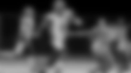 Boynton Beach quarterback quarterback Lamar Jackson tries to run past Hallandale linebacker Sh'mar Kilby-Lane during the first half, Friday, October 31, 2014.