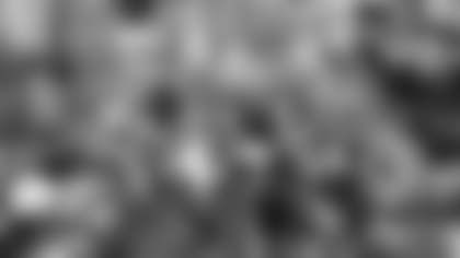 Washington QB Doug Williams is surrounded by photorgraphers after he led the Redskins to a 42-10 victory over the Denver Broncos in Super Bowl XXII in San Diego, in this Feb. 1, 1988 file photo. Williams completed 18 of 29 attempts and was named Most Valuable Player. (AP Photo)