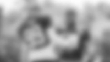 Chase Young teaches William Bradley-King some pass-rush moves after practice. (Emilee Fails/Washington Football Team)