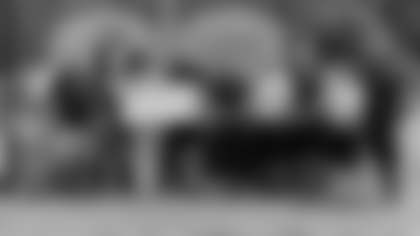 Ryan Vermillion presents the $2,000 check from Medco to head athletic trainer Dawn Bracley. Pictured from left to right are: Ronald Nelson, Brian Ross, Sah Brown, Meredith Thomas, Dawn Bracley, Ryan Vermillion, Doug Quon, Jeff Ruiz, Mark McCracken, Masahiro Takahagi and Khalid Shakur. (Zach Selby/Washington Football Team)