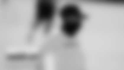 In this Aug. 18, 2020, file photo, Washington full-year coaching intern Jennifer King watches practice at the team's NFL football training facility in Ashburn, Va. For the first time in NFL history, there will be two female coaches on the sideline and a female official on the field when the Browns host the Washington Football team. King is in her first season on Washington’s staff while Callie Brownson is the chief of staff for Browns first-year coach Kevin Stefanski. Sarah Thomas became the league’s first female official in 2015, has worked in the postseason and is now making more history. (AP Photo/Alex Brandon, File)