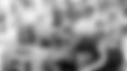 Washington kicker Nick Novak (3), right, jumps into the arms of teammate Derrick Dockery after kicking a game-winning field goal in overtime on Sunday, Oct. 2, 2005, in Landover, Md. Washington won 20-17. At left is Washington offensive lineman Casey Rabach. At center is linebacker Marcus Washington. (AP Photo/Evan Vucci)