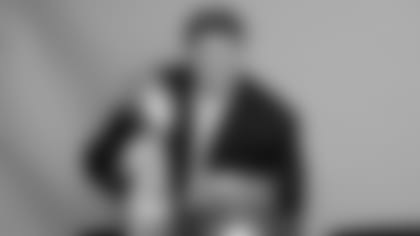 New Orleans Saints tackle Jon Stinchcomb poses with the XLIV Super Bowl trophy in 2010.