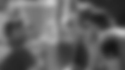 Jacksonville Jaguars passing game coordinator Brian Schottenheimer, left, talks with quarterback Trevor Lawrence, second from right, on the bench during the first half of an NFL football game against the Tennessee Titans, Sunday, Oct. 10, 2021, in Jacksonville, Fla. (AP Photo/Phelan M. Ebenhack)