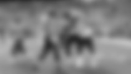 Rashaad Penny is congratulated by fellow running backs Chris Carson, C.J. Prosise and Travis Homer after his touchdown in the third quarter.