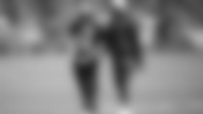 In this August 2014 photo, Seahawks vice president of player engagement Maurice Kelly walks with running back Marshawn Lynch.