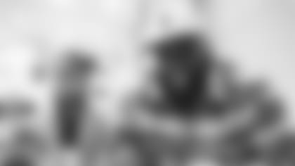 An image from the Dec. 20, 2022 community development event.  Texans defensive linemen gave holiday gifts to students at Isaacs Elementary School in Houston, TX.