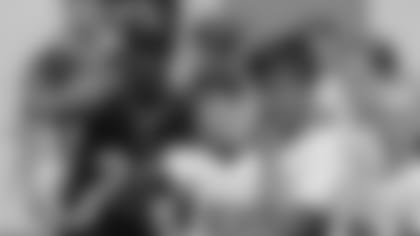 Player Giovani Bernard of the Cincinnati Bengals coaches a young team during the final tournament for the UK's NFL Flag Championship, featuring qualifying teams from around the country, at the Tottenham Hotspur Stadium in London, Wednesday, July 3, 2019. The new stadium will host its first two NFL London Games later this year when the Chicago Bears face the Oakland Raiders and the Carolina Panthers take on the Tampa Bay Buccaneers. (AP Photo/Frank Augstein)