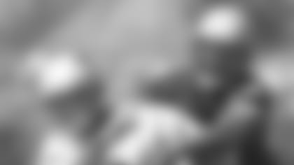 New England Patriots' rookie tight end Jabari Holloway (49) keeps a firm grip on the ball as Patriots' rookie linebacker T.J. Turner, right, applies pressure after Halloway caught a pass during rookie minicamp in Foxboro, Mass., Saturday, April 28, 2001. The New England Patriots welcomed 10 rookie free agents and 10 draft choices to the minicamp on Friday.