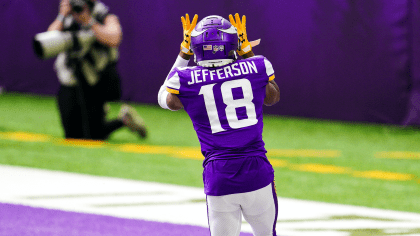 Minnesota Vikings wide receivers Justin Jefferson (18) and Adam Thielen (19)  celebrate after Jefferson scored a touchdown against the New York Jets,  during the second half of an NFL football game Sunday