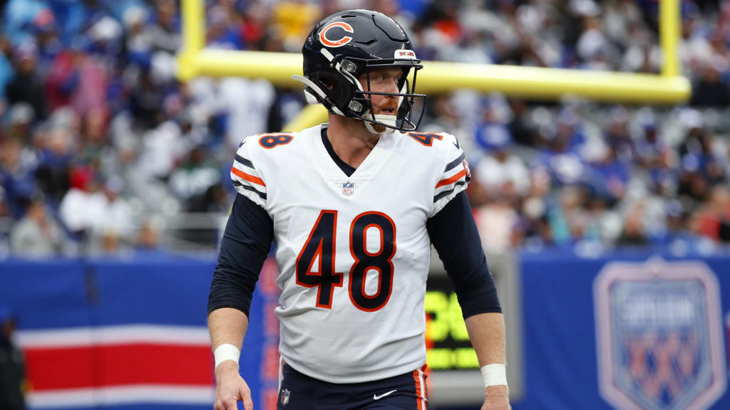 Chicago Bears long snapper Patrick Scales holds his daughter