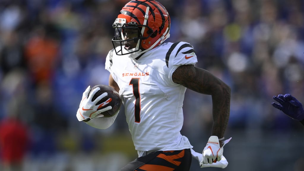 Cincinnati Bengals wide receiver Ja'Marr Chase, left, and tight end C.J.  Uzomah talk on the field after losing to the Los Angeles Rams in the NFL Super  Bowl 56 football game Sunday