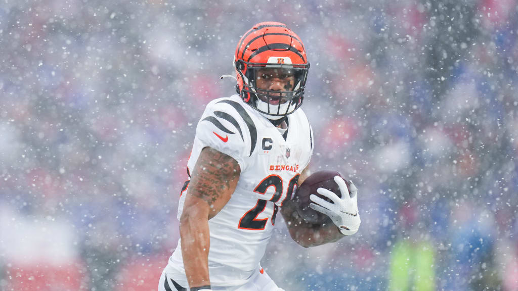 Cincinnati Bengals running back Joe Mixon holds the Lamar Hunt trophy as  Ja'Marr Chase, left and Tee HIggins, center, watch after they beat the  Kansas City Chiefs in the NFL AFC Championship