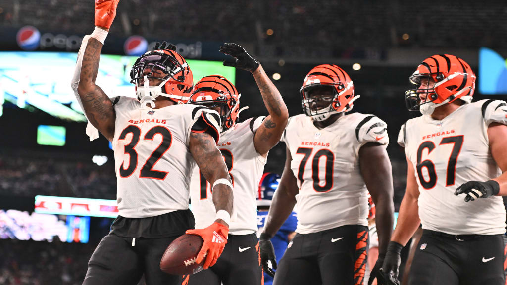 Cincinnati Bengals running back Chris Evans (25) and offensive tackle D'Ante  Smith (70) celebrate after Evans scored a touchdown during the second half  of an NFL football game, Sunday, Jan. 9, 2022