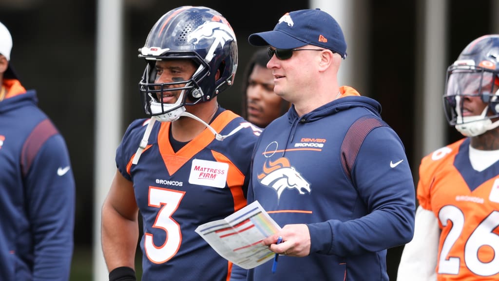 Denver Broncos quarterback Russell Wilson (3) grets his sons Future, left,  and Win, before taking part in drills during the NFL football team's  training camp Monday, Aug. 1, 2022, at the team's