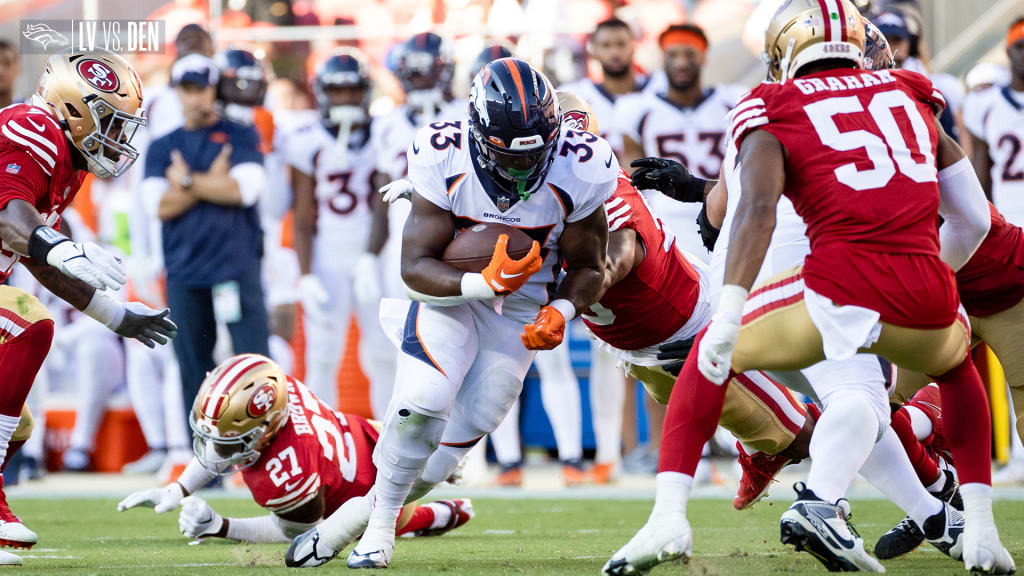 Denver Broncos running back Javonte Williams (33) jumps over the Raiders'  free safety Trevon Mo …