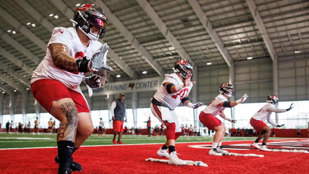 TAMPA, FL - MAY 13: Tampa Bay Buccaneers Logan Hall (90) talks with a team  official before the Tampa Bay Buccaneers Rookie Minicamp on May 13, 2022 at  the AdventHealth Training Center