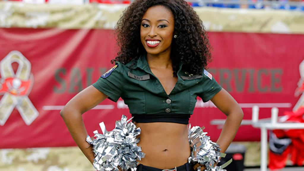 Miami Dolphins Cheerleader performs with her pom poms on the field