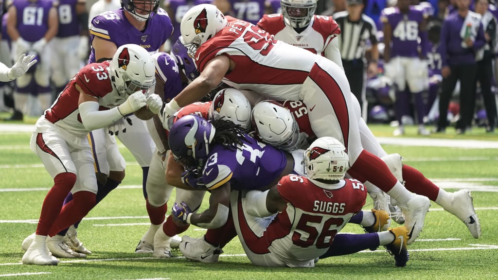 Arizona Cardinals' Fred Wakefield (87) and Detroit Lions Ernie Sims (80)  are separated by line judge Ron Marinucci during the second quarter of  their football game Sunday, Nov. 19, 2006, in Glendale