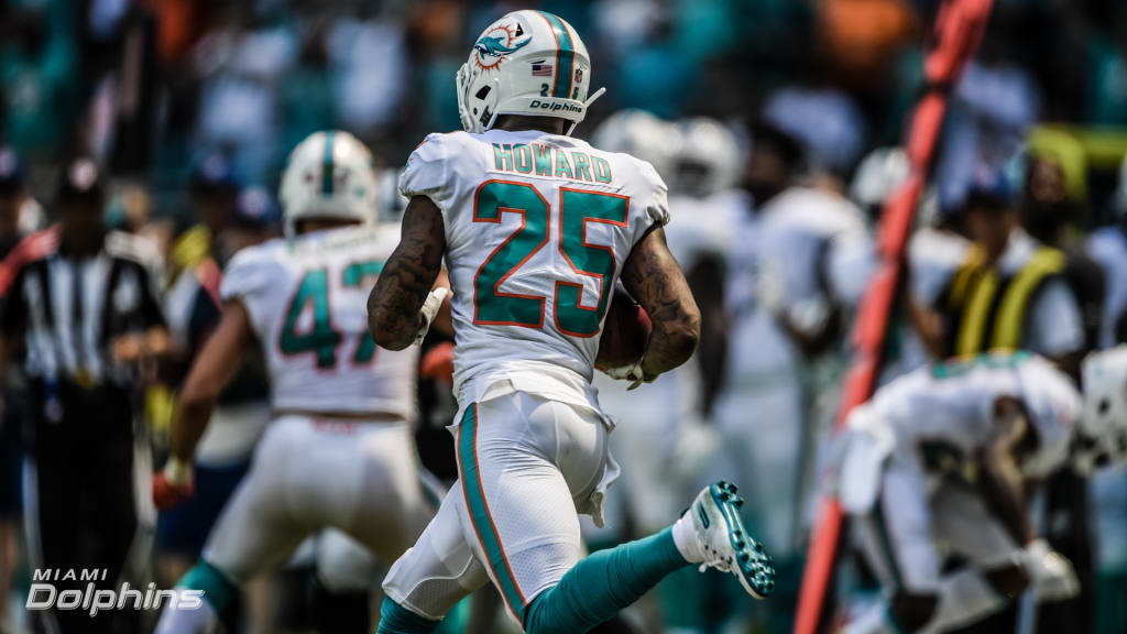 Dallas Cowboys wide receiver Amari Cooper (19) catches a pass for a  touchdown as Miami Dolphins cornerback Xavien Howard (25) defends in the  first half of a NFL football game in Arlington