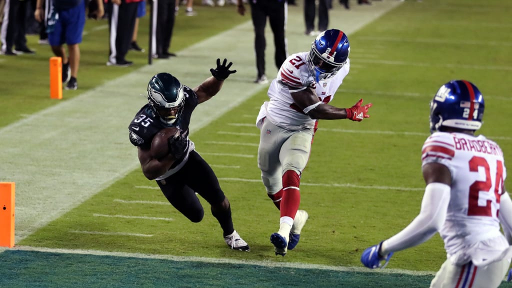 Boston Scott of the Philadelphia Eagles is tackled by Kareem