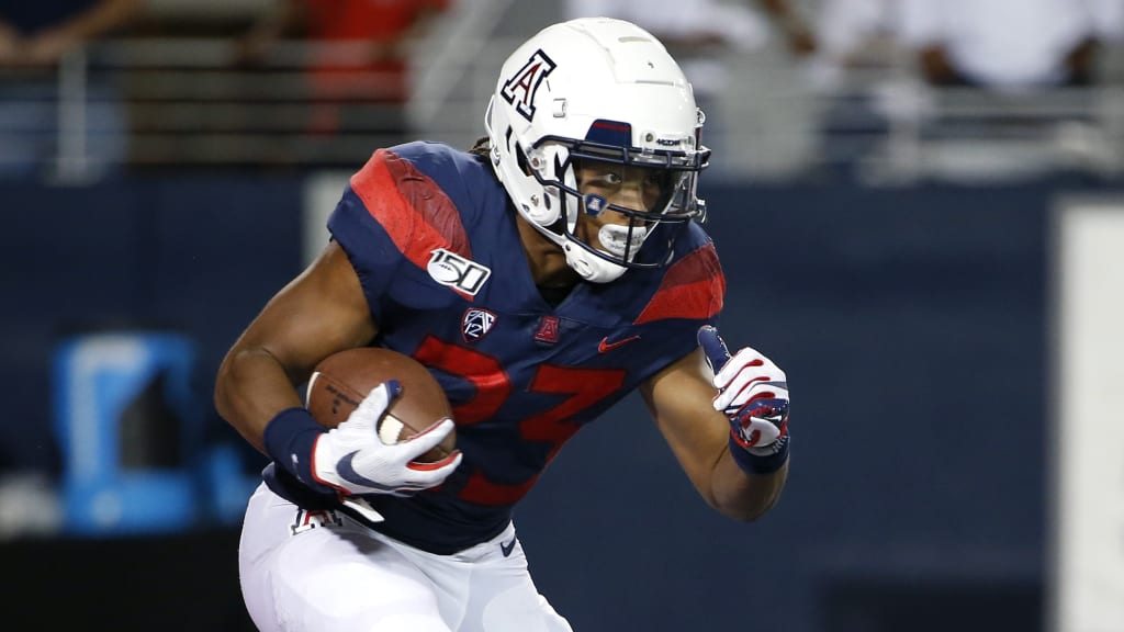 Running back Gary Brightwell of the Arizona Wildcats runs the ball to