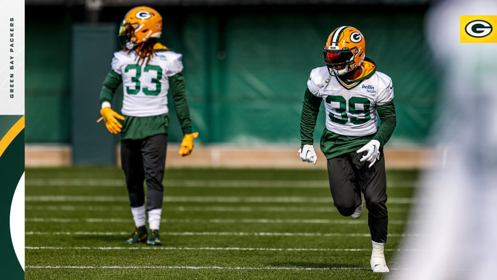 Green Bay Packers Rookie Running The Ball With A Green Background