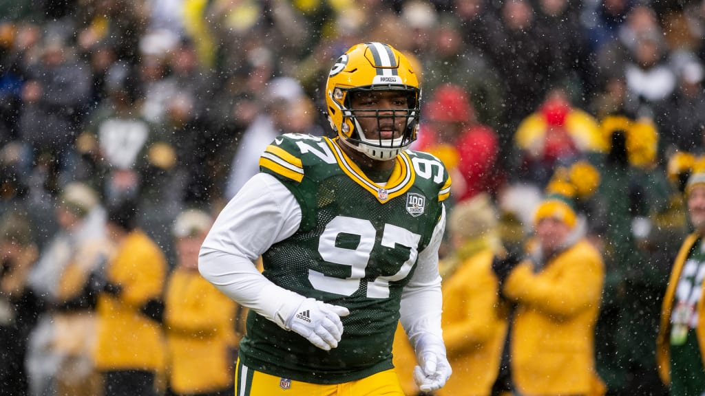 Green Bay Packers nose tackle Kenny Clark, left, exchanges jerseys