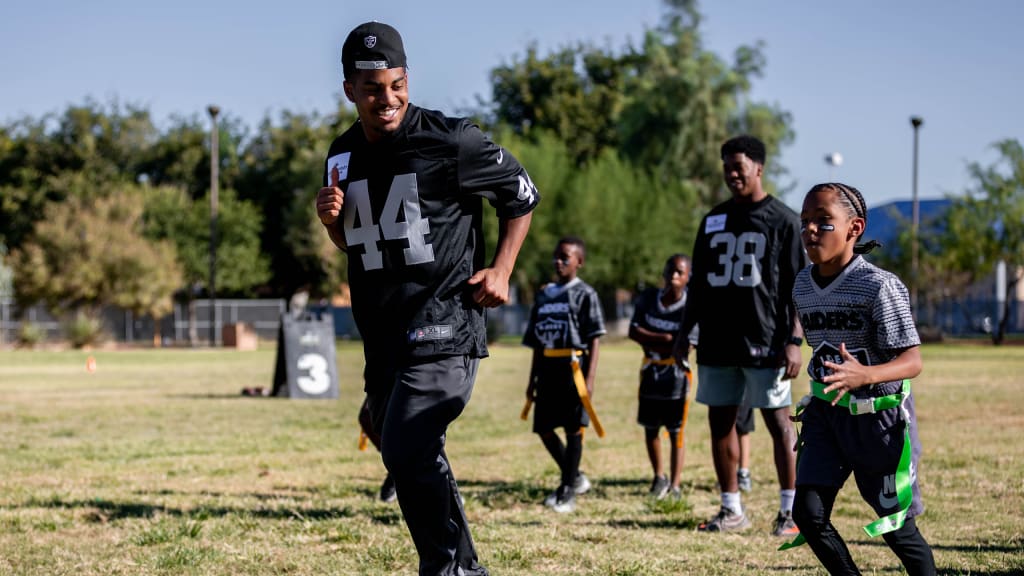 Las Vegas Raiders players lead elementary school students at football camp  in advance of Silver & Black Flag League kickoff