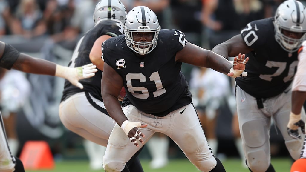 Oakland Raiders head coach Jon Gruden talks with center Rodney Hudson (61)  and quarterback Derek Carr, left rear, during the second half of an NFL  football game against the Miami Dolphins, Sunday, …