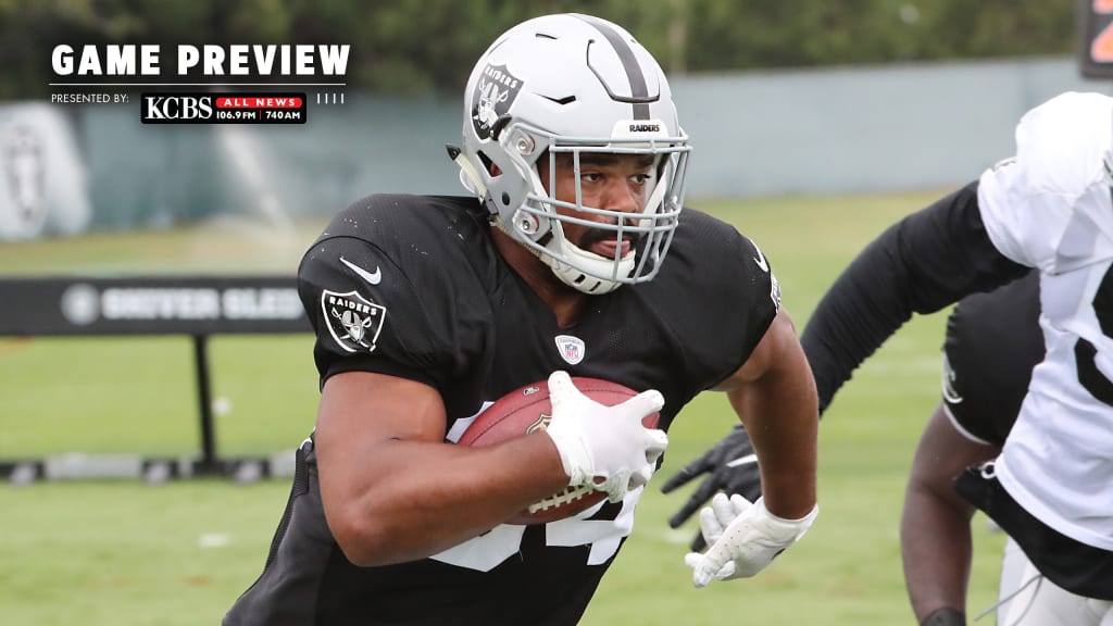 An Oakland Raiders player holds up a helmet at the start of a NFL preseason  football game again …