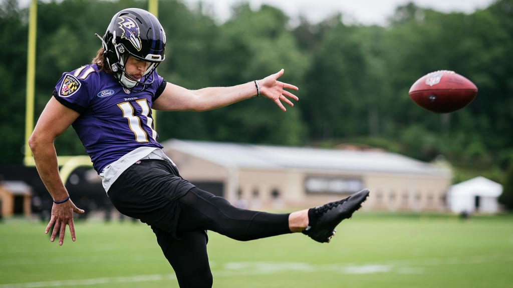 Baltimore Ravens' Jordan Stout (11) looks on after holding for