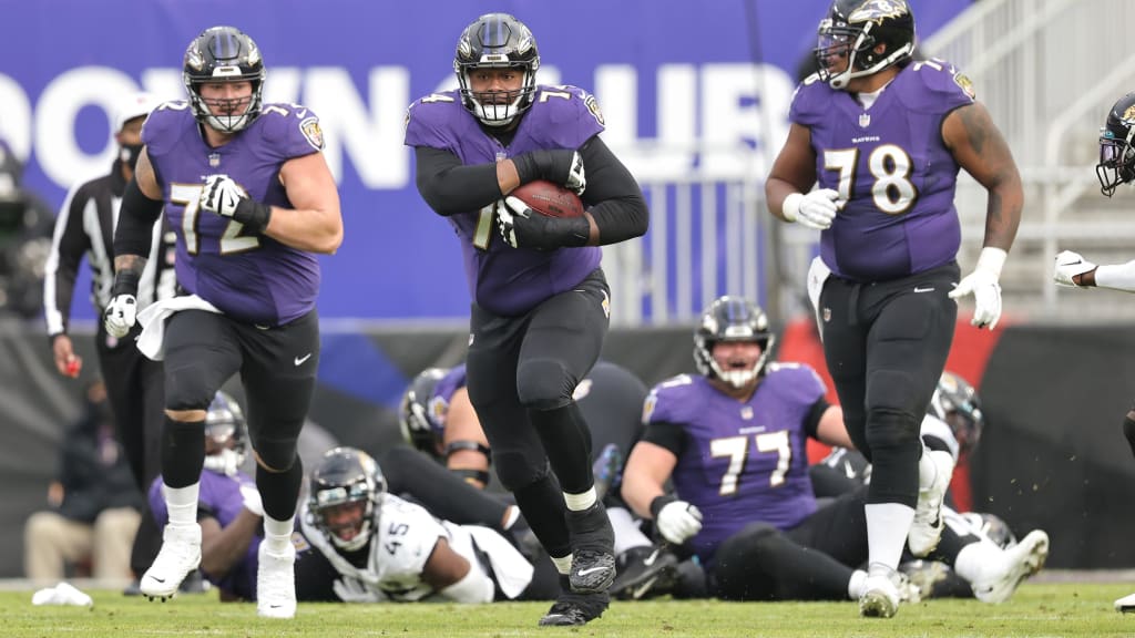 Joey Porter of the Miami Dolphins causes a fumble as the Baltimore