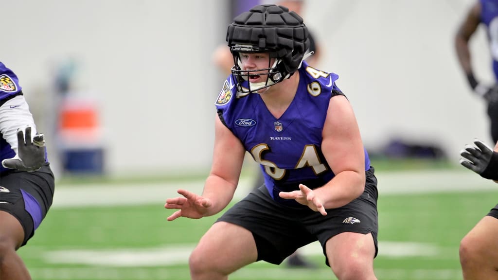 Baltimore Ravens center Tyler Linderbaum (64) signals during an