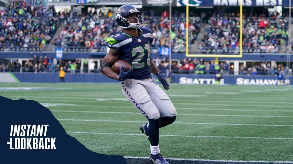 A Seattle Seahawks fan wearing a Russell Wilson jersey waves a