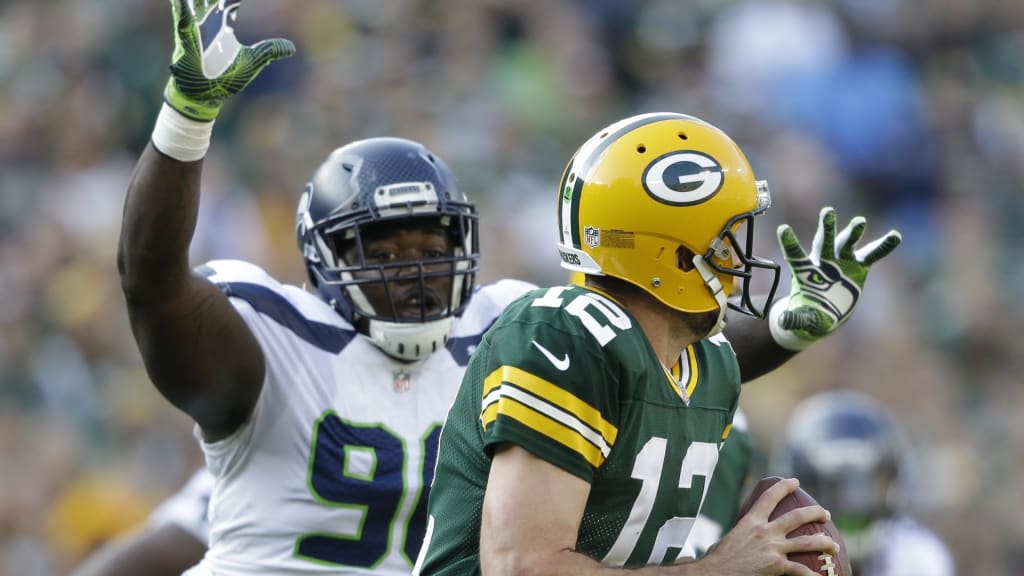 Seattle Seahawks quarterback Russell Wilson hands off to running back  Marshawn Lynch against the Green Bay Packers' at CenturyLink Field in  Seattle, Washington during a Monday Night Football gameSeptember 24, 2012.  Russell