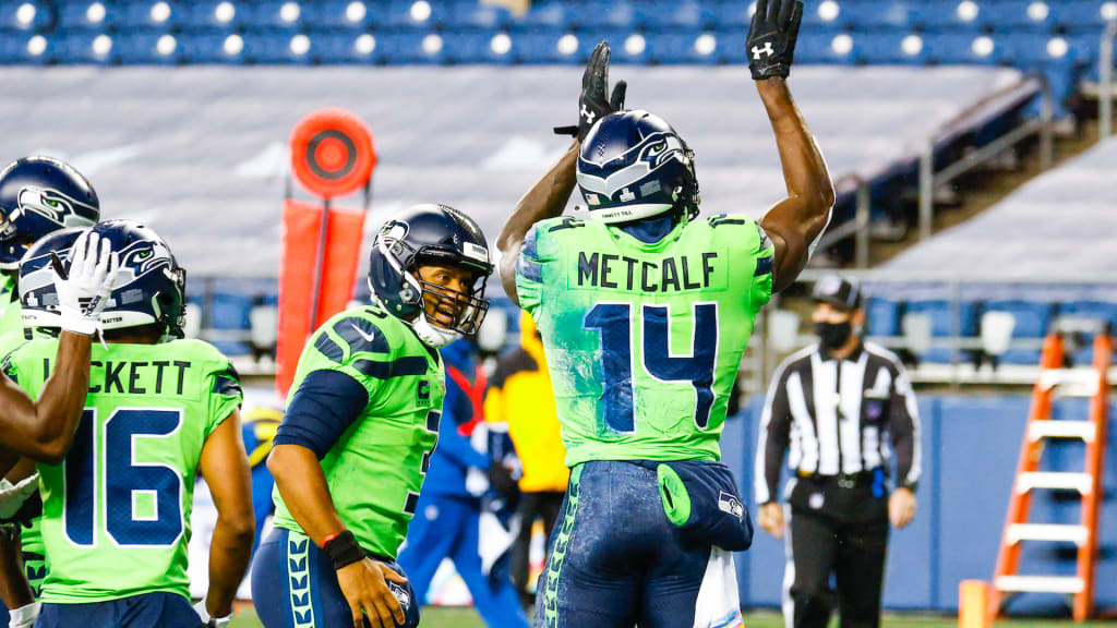 A Seattle Seahawks fan wearing a Russell Wilson jersey waves a