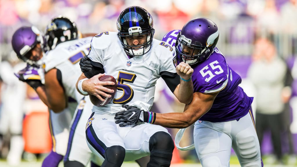 Baltimore Ravens quarterback Lamar Jackson (8) throws the ball as he is hit  by Minnesota Vikings defensive tackle Armon Watts (96) during the second  half of an NFL football game, Sunday, Nov.