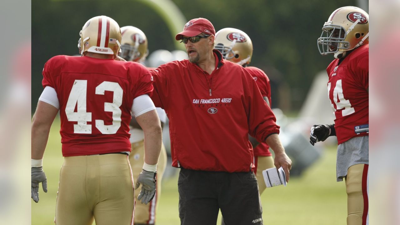 Tom Rathman of the San Francisco 49ers looks on during pregame