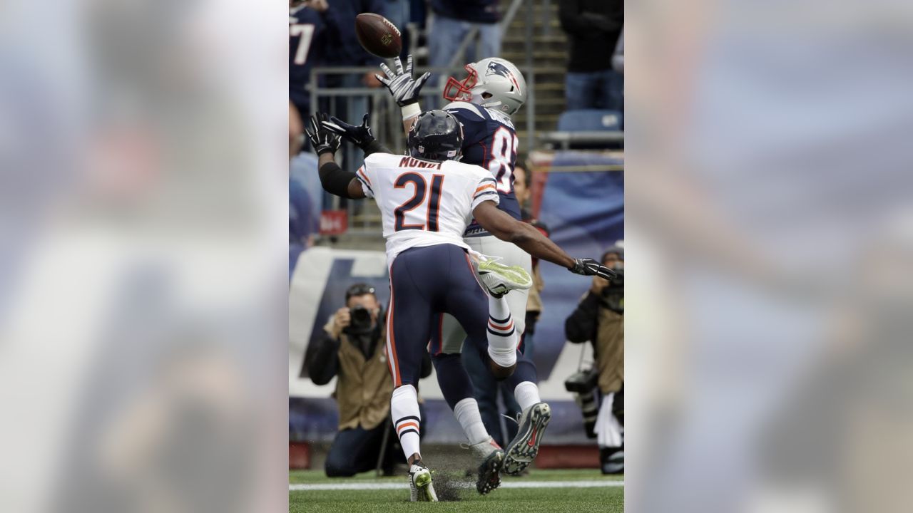 New England Patriots quarterback Tom Brady (12) passes over Chicago Bears  defensive end Lamarr Houston (99) in the first half of an NFL football game  on Sunday, Oct. 26, 2014, in Foxborough