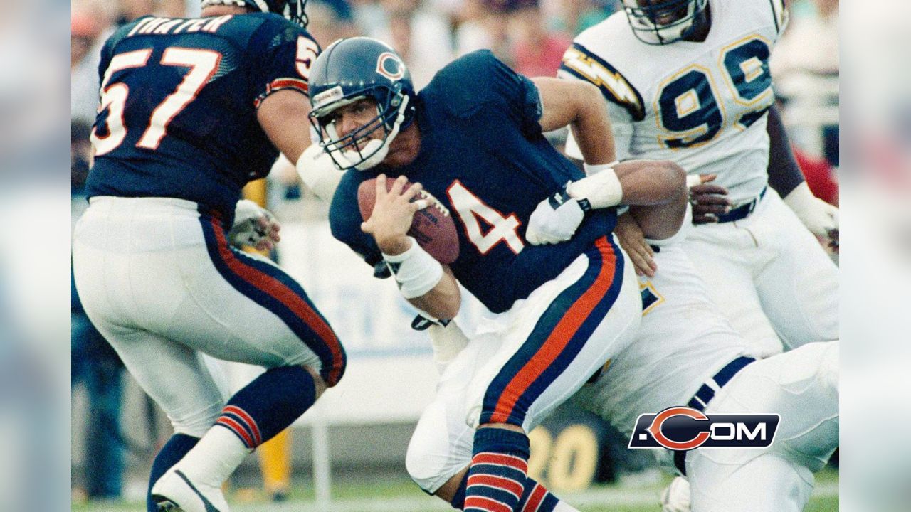 Jim Harbaugh of the Chicago Bears looks to hand off circa 1980s