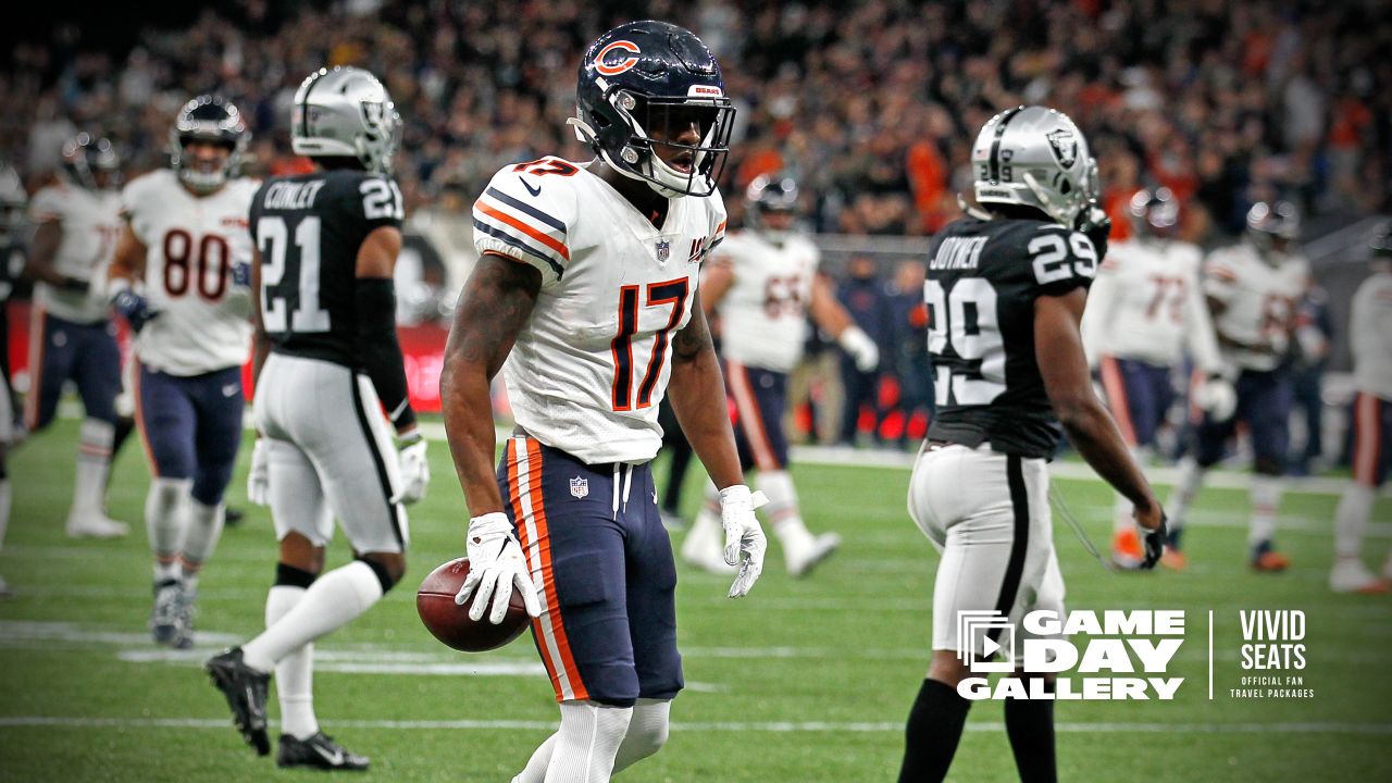 Oakland Raiders running back Josh Jacobs (28) breaks a tackle and goes in  for a touchdown during the first half of an NFL football game against the  Chicago Bears at Tottenham Hotspur