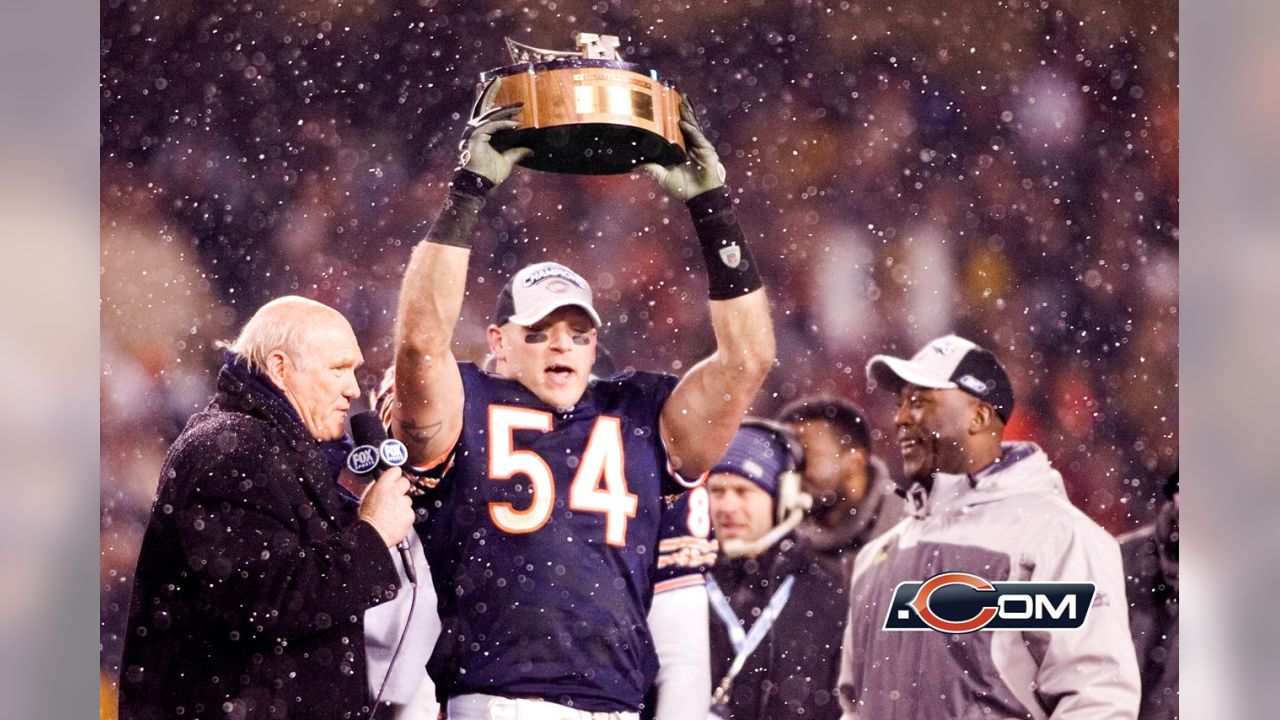 Chicago Bears' Brian Urlacher (54) holds up the NFC Championship Trophy  after the Bears beat the New Orleans Saints 39-14 in the NFC Championship  game at Soldier Field in Chicago on January