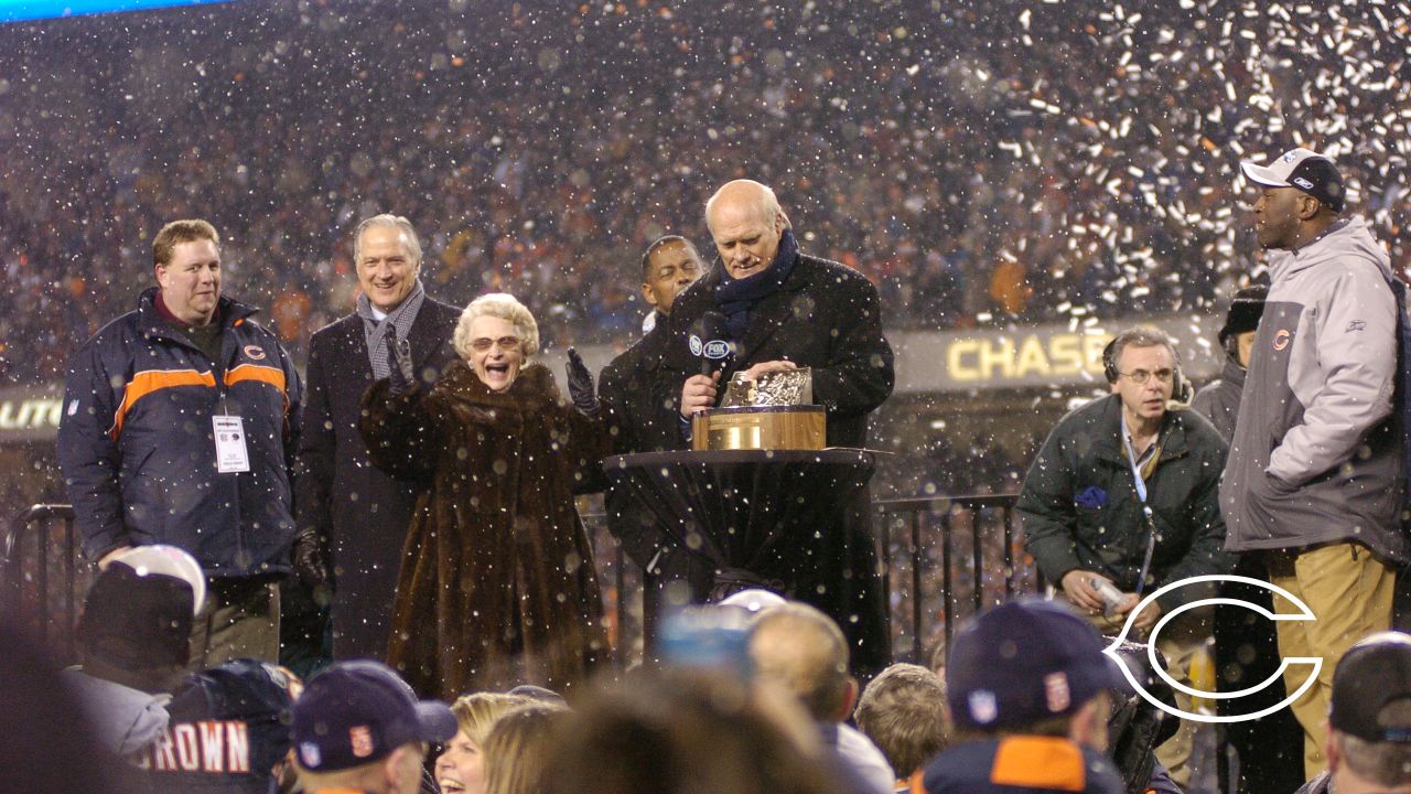 Chicago Bears chairman Michael McCaskey, left, and owner Virginia McCaskey  , center, react as they are presented with the George Halas Trophy after  the Bears beat the New Orleans Saints, 39-14, to