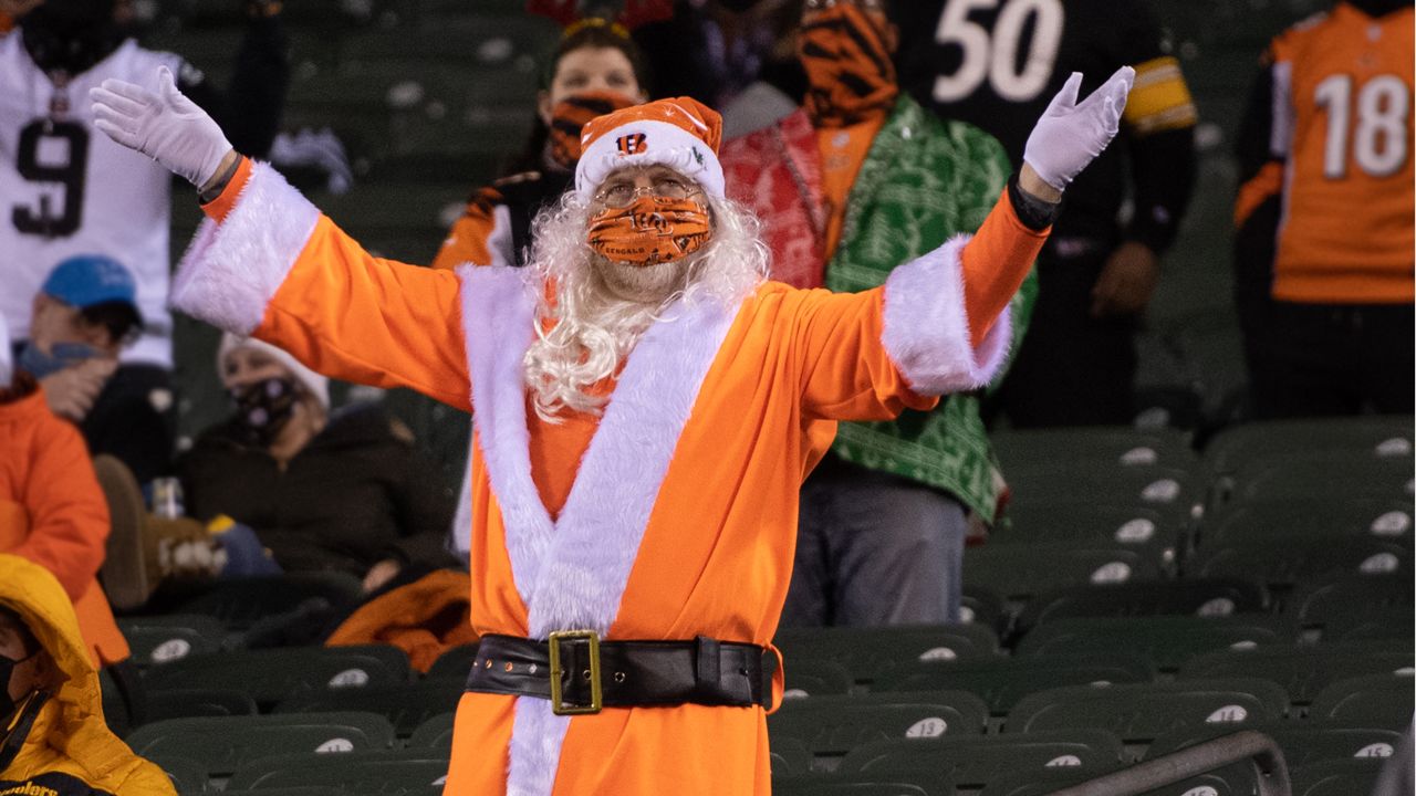 A Tennessee Titans fan dressed as Santa Claus watches in the first