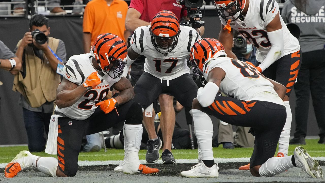 Cincinnati Bengals running back Joe Mixon (28) scores a touchdown against  Las Vegas Raiders free safety Trevon Moehrig (25) during the first half of  an NFL football game, Sunday, Nov. 21, 2021