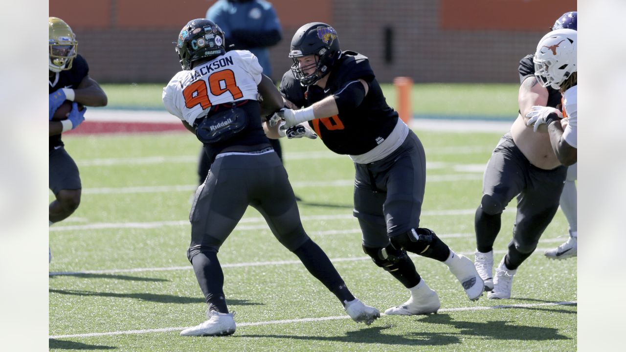 Wake Forest defensive lineman Carlos Basham Jr. talks to a coach during  American Team practice Wednesday, Jan. 27, 2021, in Mobile, Ala., for the  Senior Bowl college football game. (AP Photo/Rusty Costanza