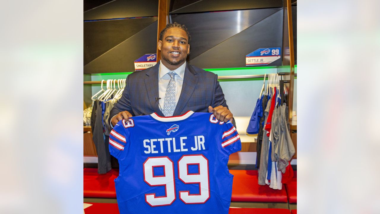 Bills defensive tackle Tim Settle shows off jersey number 99