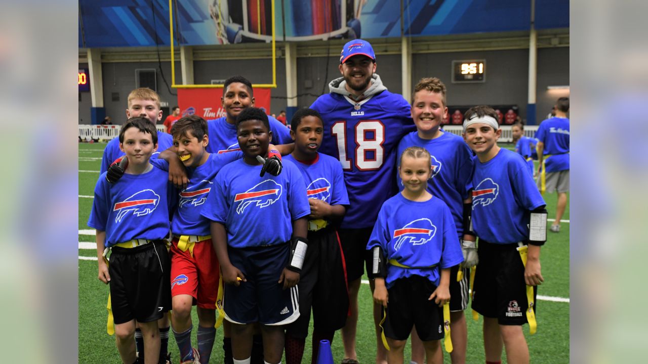 Julia Crossley delivers game ball to referee Carl Cheffers as part of NFL  PLAY 60